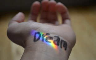 closeup photo of human wrist with Dream text