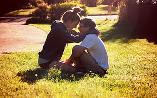 boy and girl sitting on grass