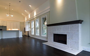 gray brick fireplace mantel placed inside white painted room