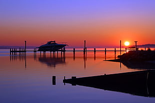 silhouette of boat on dock during sunset HD wallpaper