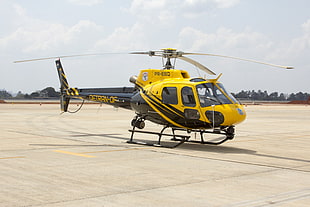 yellow and black helicopter on white surface