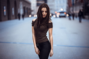 woman in brown cold-shoulder top and black bottoms