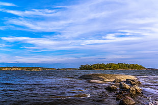 ocean under white and blue sky at daytime, sweden