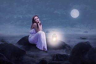 woman wearing white dress on rock during night time painting