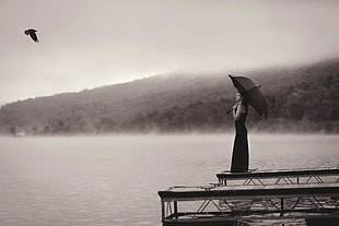 woman under umbrella on dock HD wallpaper
