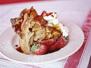 brown apple pie beside with 3 slice of strawberries