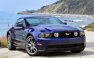 blue Ford Mustang at beach