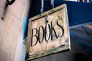 square gray and black wooden BOOKS signage