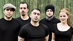 four men with women wearing black shirts