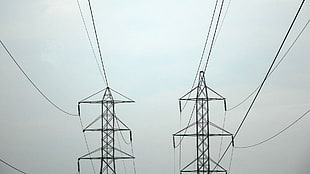 white sky over electric power lines and towers