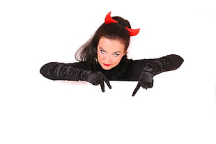 woman in black gloves and red devil alice band