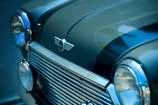 selective focus photography of classic black car