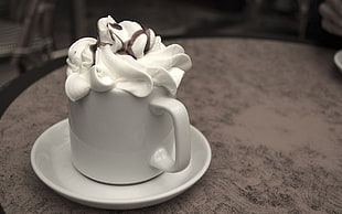 whipped cream drink in white ceramic mug and saucer