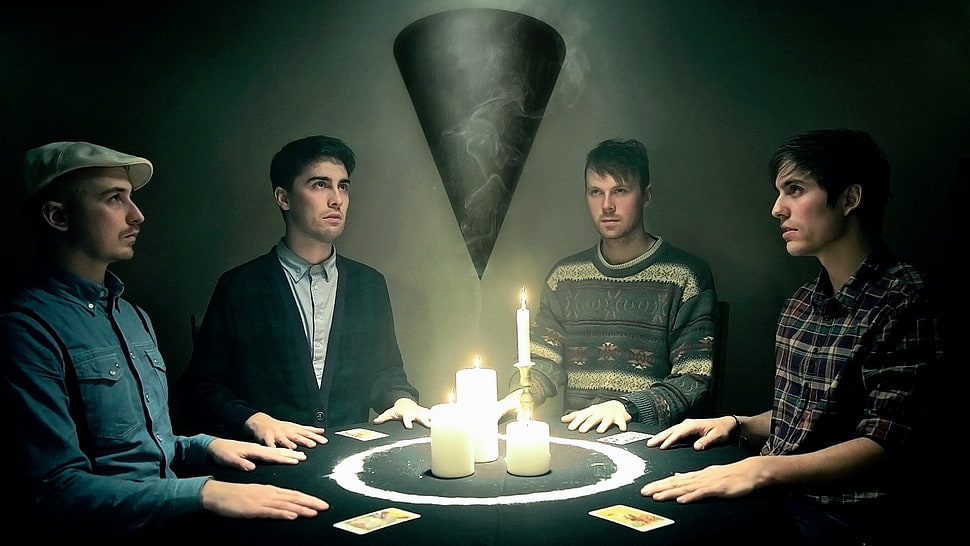 four people sitting in front of table HD wallpaper