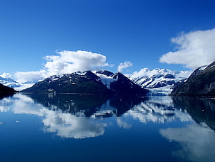 photo of mountain near body of water
