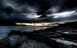panorama photography of calm body of sea with black sky