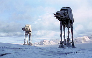two Star Wars AT-AT on snow field during daytime
