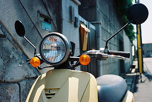 close up photo of beige motor scooter
