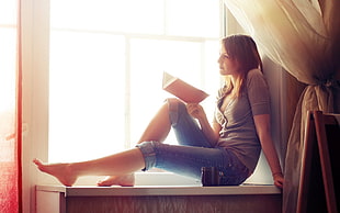 woman in the window while reading book HD wallpaper