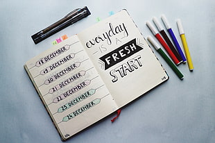 five assorted-color markers, Notebook, Inscription, Markers
