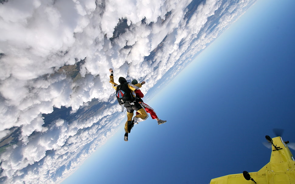 two person flying above white clouds during daytime HD wallpaper