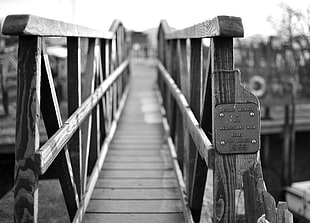 greyscale photo of wooden bridge