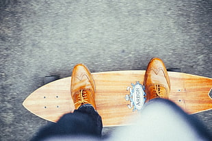 photo of person riding cruiser skateboard
