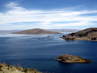 top view of body of water near on brown mountain, bolivia, peru