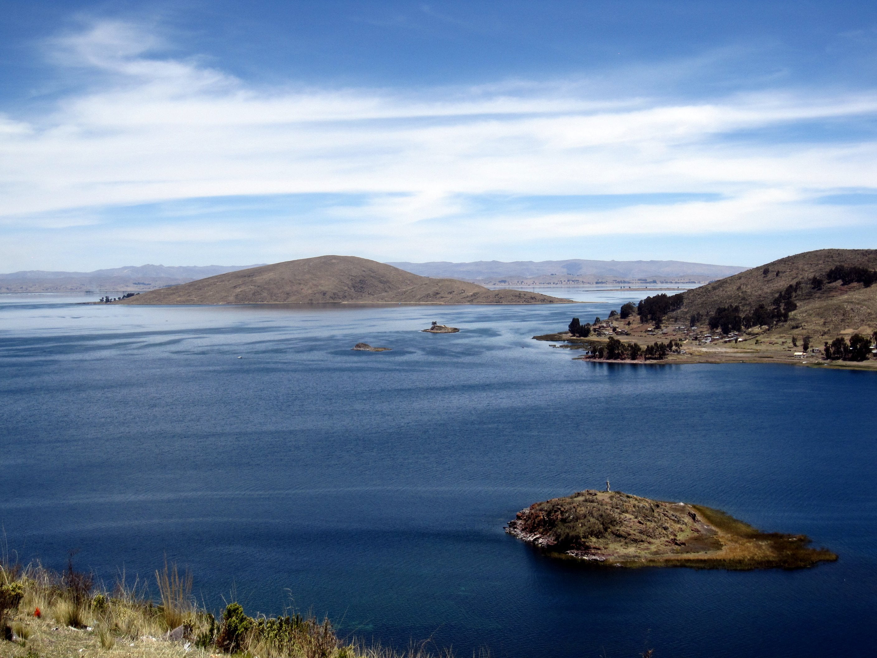 top view of body of water near on brown mountain, bolivia, peru