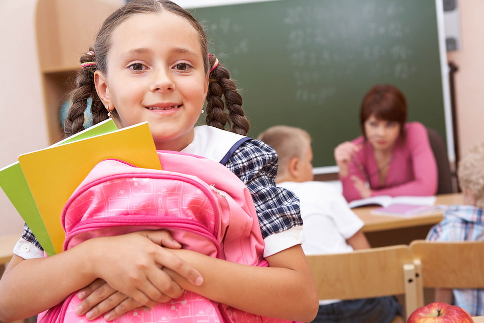 girl holding pink backpack taking photo HD wallpaper