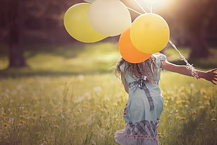 tilt lens photography of girl with ballons on floral field HD wallpaper