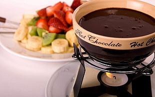 black and brown Hot Chocolate fondue near variety of fruits