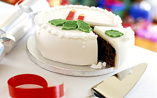 sliced white cake on round gray stand