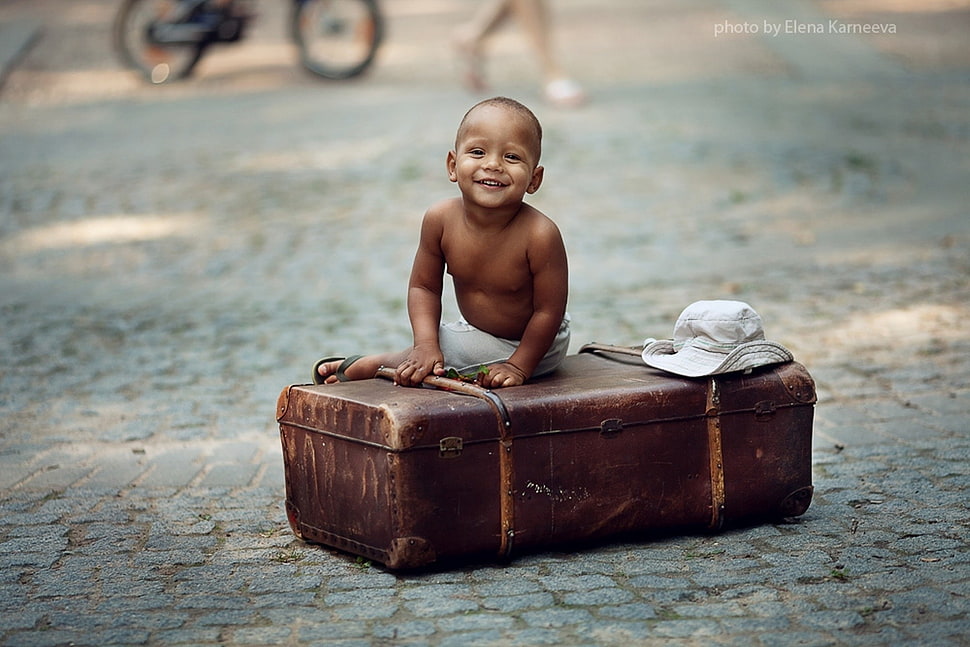 topless baby boy sitting on brown suit case HD wallpaper