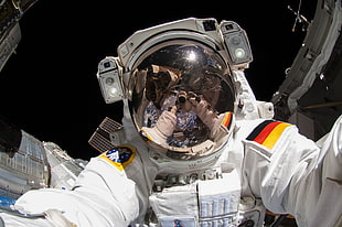 astronaut taking selfie at space