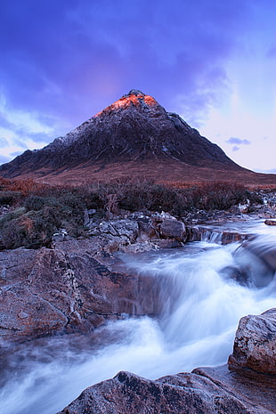 low angled view of active volcano near rippling body of water, scotland HD wallpaper