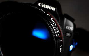 shallow focus photography of black Canon DSLR camera