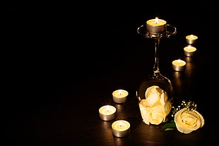 seven lighted tea light candles