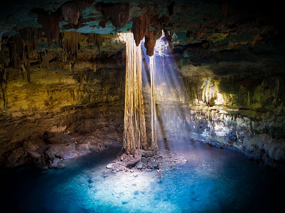 person under cave HD wallpaper