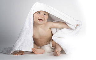 baby with white bathroom towel
