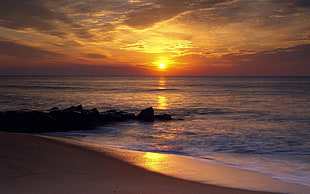 photograph of body of water during sunset