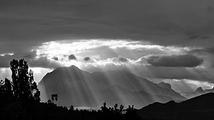 sun rays through clouds near mountain HD wallpaper