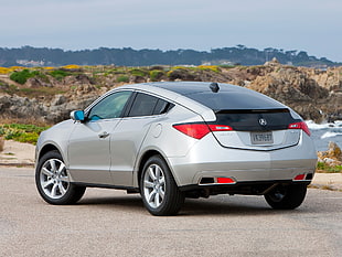 silver Acura compact SUV parked on cement pavement during daytime HD wallpaper