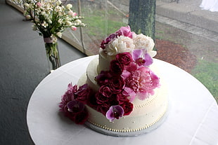 pink and white flower accent cake on white table