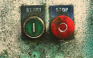 green start and red stop buttons on wall