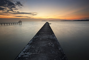 Brown Dock Beside Body of Water during Sunrise