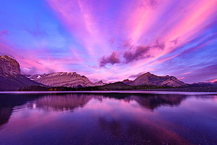 mountains surrounded by water under purple skies, kananaskis