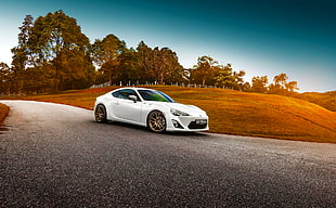 white coupe on empty road HD wallpaper