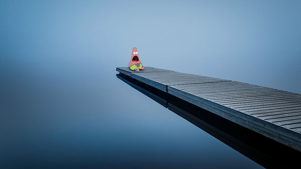 patrick sitting on gray cliff HD wallpaper