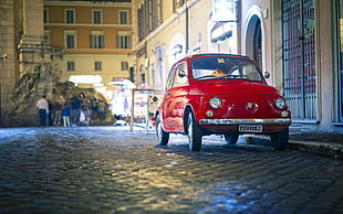 photography of red car on street at night